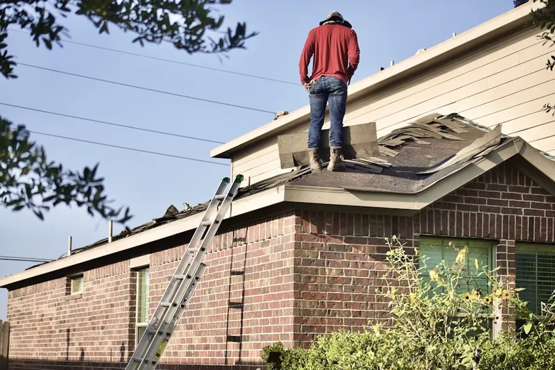 Professional roofer working on a residential roof in Rodeo
